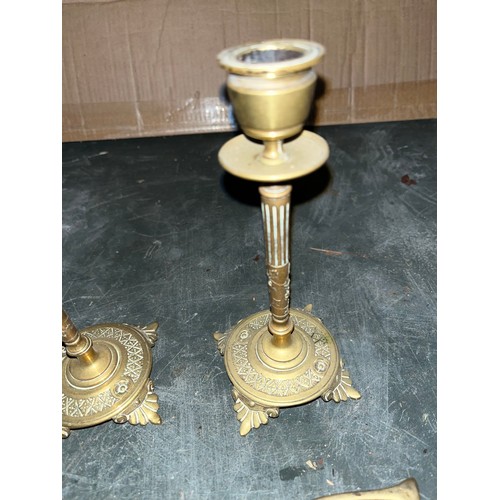 542 - Two brass candlesticks and a pair of coal tongues