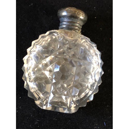 47 - Silver toppeed perfume bottle in cut crystal glass. Hobnail pattern possibly Harvard pattern by Bacc... 