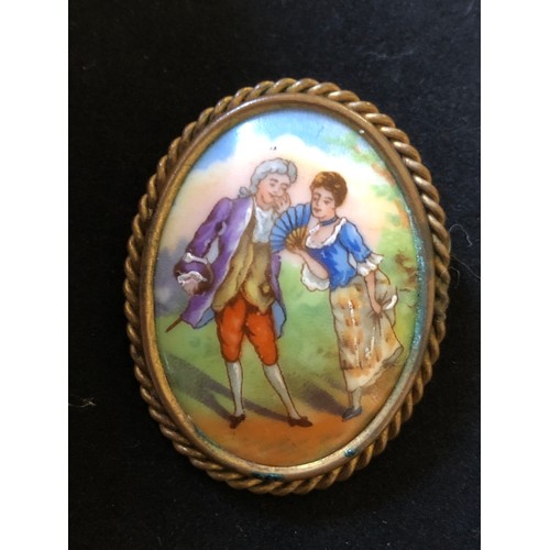 39 - Pretty Limoges France convex hand painted porcelain brooch set in a ropework gold plated frame with ... 
