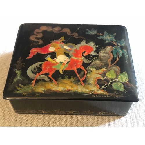 160 - A beautiful Palekh Russian lacquered painted cigarette box with warrior riding a horse in full armou... 