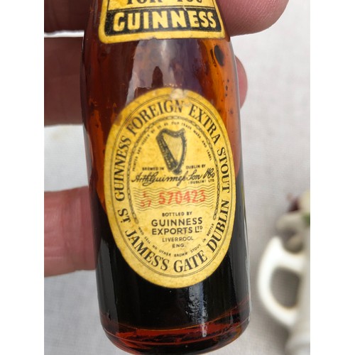 21 - Miniature Guinness bottle Staffordshire cup containing flowers