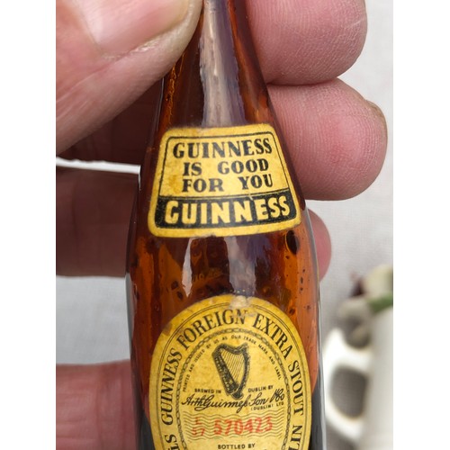 21 - Miniature Guinness bottle Staffordshire cup containing flowers