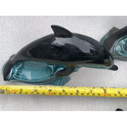 322 - Set of graduating dolphins on waves by Poole pottery