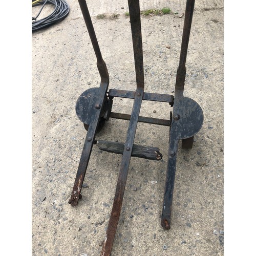 161 - Restoration project. A metal frame with cast iron wheels. Some kind of hand pulled truck, probably f... 