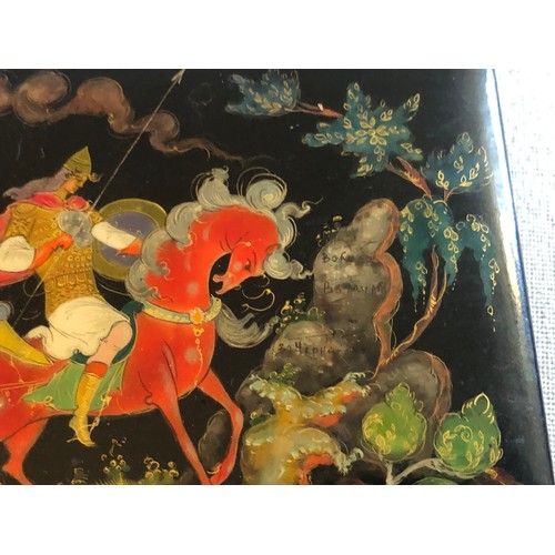 179 - A beautiful Palekh Russian lacquered painted cigarette box with warrior riding a horse in full armou... 