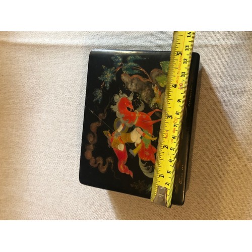 179 - A beautiful Palekh Russian lacquered painted cigarette box with warrior riding a horse in full armou... 