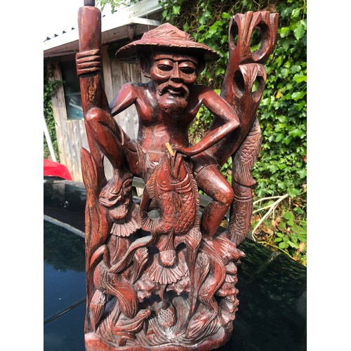 193 - Large wooden sculpture of a mud man fishing complete with rod and line