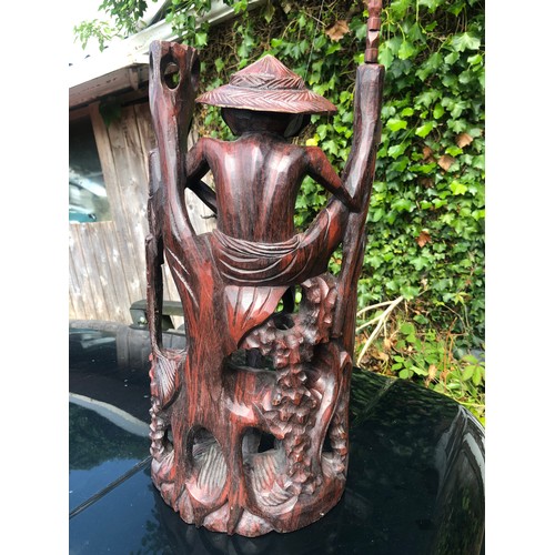 193 - Large wooden sculpture of a mud man fishing complete with rod and line