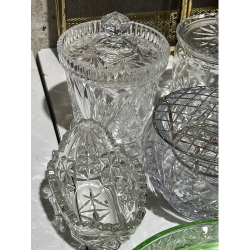 409 - A collection of cut crystal lidded jars a bowl and a green glass fish dish