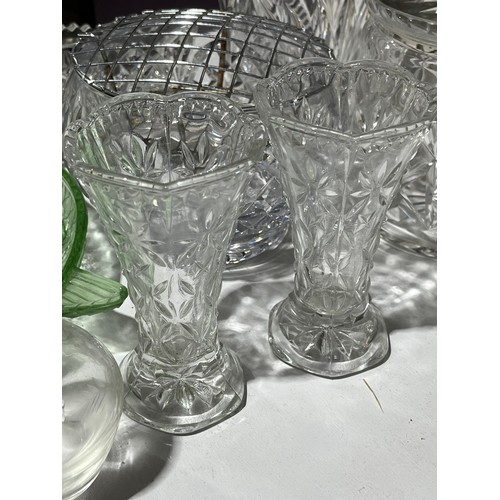 409 - A collection of cut crystal lidded jars a bowl and a green glass fish dish