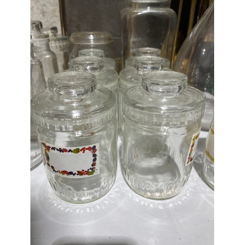 411 - Glass storage jars, all with lids