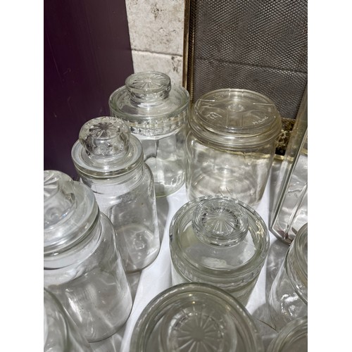 411 - Glass storage jars, all with lids