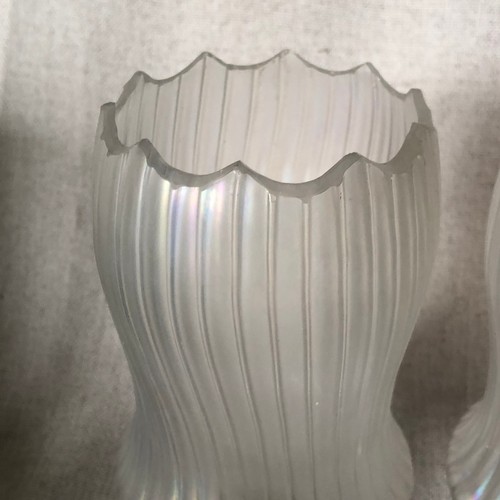 454 - A pair of iridescent glass vases on silver plated bases