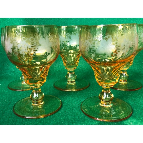 398 - Five John Walsh vine and tendril wine glasses in Amber glass.