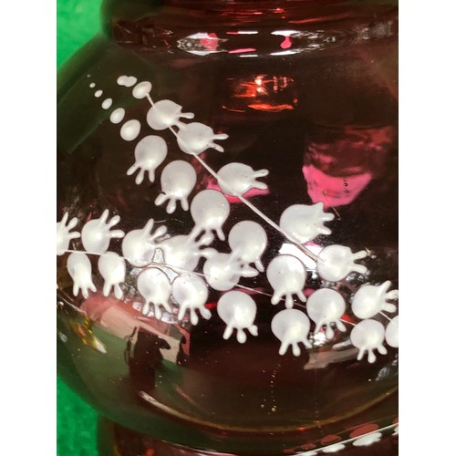 402 - Cranberry glass vase decorated in lily-of-the-valley white enamel.