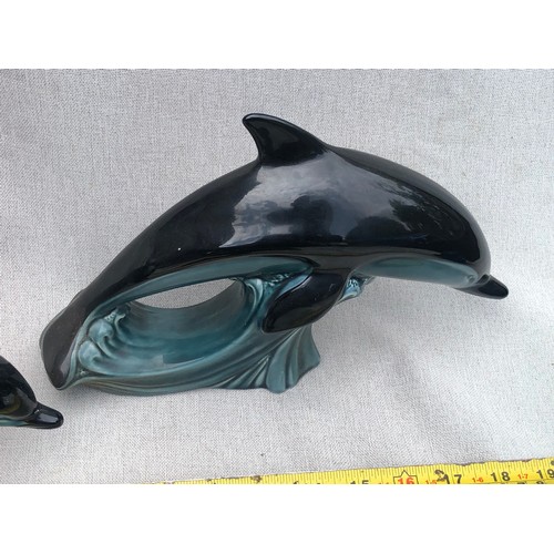 601 - Set of graduating dolphins on waves by Poole pottery