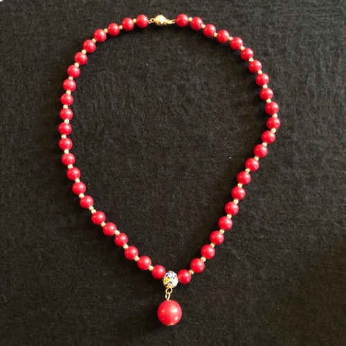 6 - a red coral beaded necklace with gold colour spacers and enamel clasp