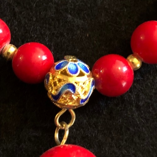 6 - a red coral beaded necklace with gold colour spacers and enamel clasp