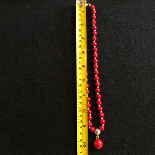 6 - a red coral beaded necklace with gold colour spacers and enamel clasp