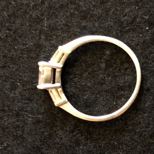 17 - A silver square cut white stone and two tampered stones on shoulders ring