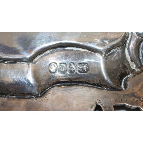 203 - A Victorian round scallop shaped salver with raised and engraved floral and leaf decoration, on 3 sp... 