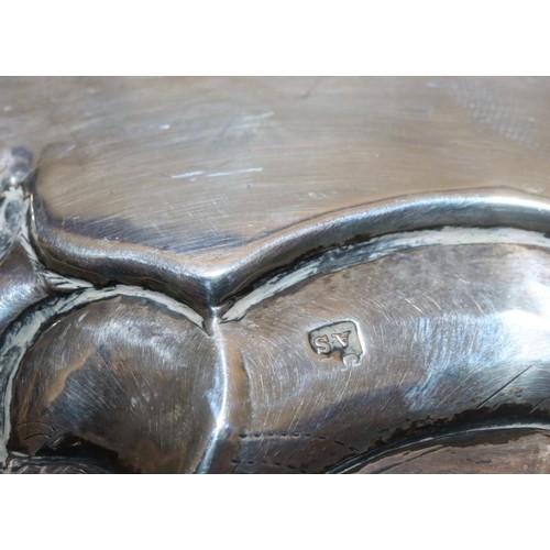 203 - A Victorian round scallop shaped salver with raised and engraved floral and leaf decoration, on 3 sp... 