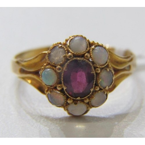 63 - OPAL AND ruby like RING, a yellow gold ring high karat gold set with a central oval garnet surrounde... 
