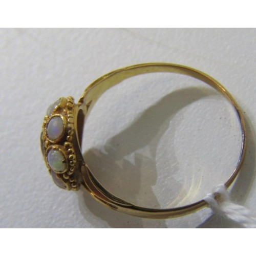 63 - OPAL AND ruby like RING, a yellow gold ring high karat gold set with a central oval garnet surrounde... 
