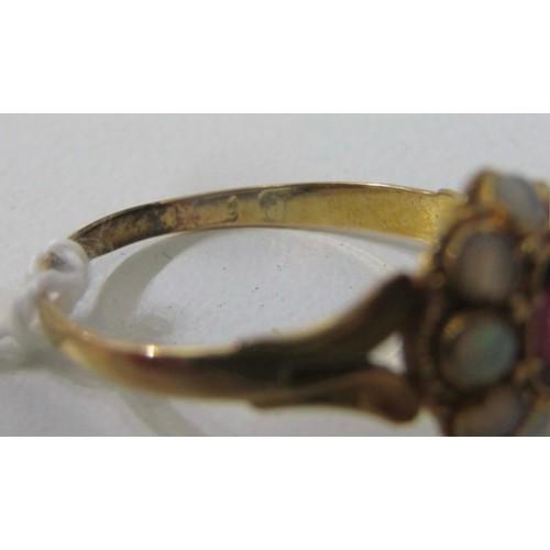 63 - OPAL AND ruby like RING, a yellow gold ring high karat gold set with a central oval garnet surrounde... 