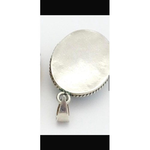 275 - Silver pendant with Turquoise center stone