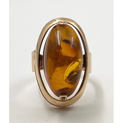 276 - A LARGE AMBER STONE SET IN RING HAND CRAFTED IN 14K ROSE GOLD. 7.2gms size M