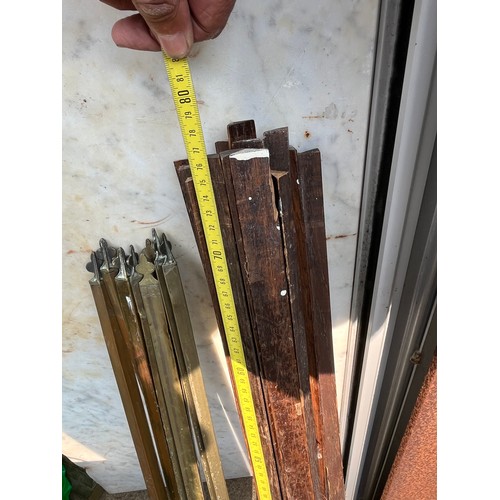 510 - Quantity of wood and brass stair rods with some clamps
