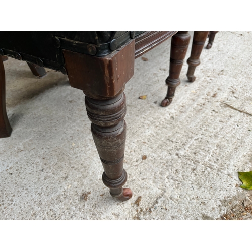 535 - Set of 4 rare Georgian carved chairs with front wheels and spring seats covered with leather.
