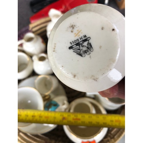 1060 - Basket of antique Goss posy vases etc.