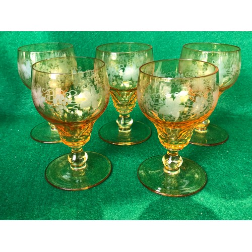 1115 - Five John Walsh vine and tendril wine glasses in Amber glass.