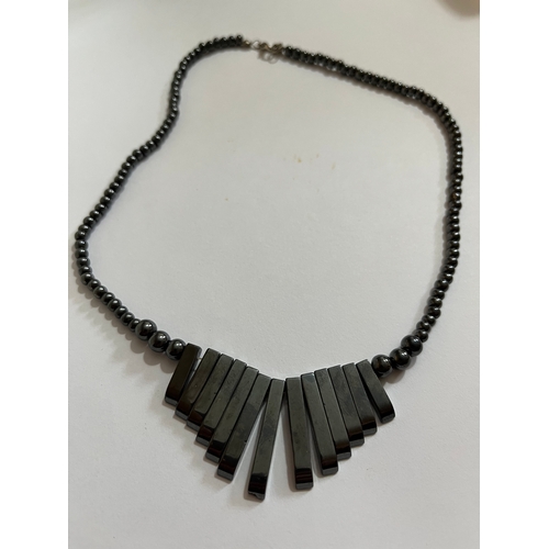 1619 - hematite bib or collar necklace featuring a graduated fringe design. The necklace is made from dark ... 