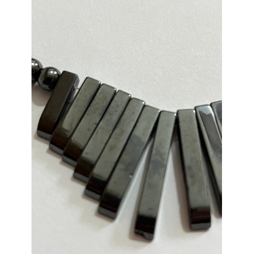 1619 - hematite bib or collar necklace featuring a graduated fringe design. The necklace is made from dark ... 