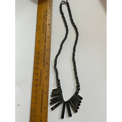 1619 - hematite bib or collar necklace featuring a graduated fringe design. The necklace is made from dark ... 