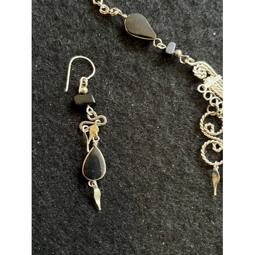 1857 - An Indian white metal necklace and earring set with black agate type stones.
