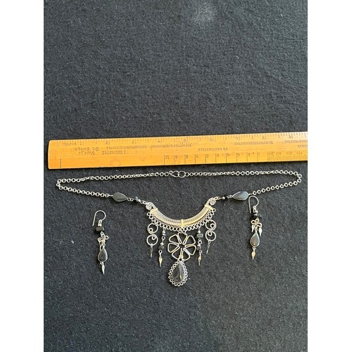 1857 - An Indian white metal necklace and earring set with black agate type stones.
