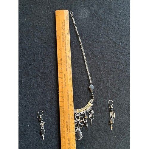 1857 - An Indian white metal necklace and earring set with black agate type stones.