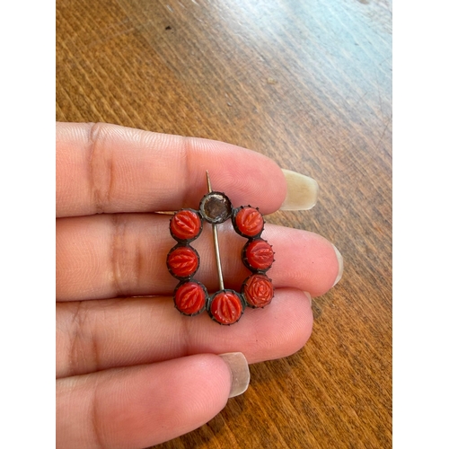 22 - A natural carved coral georgian brooch silver on gold one coral missing