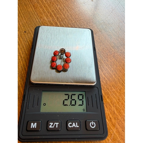 22 - A natural carved coral georgian brooch silver on gold one coral missing