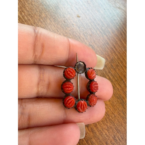 22 - A natural carved coral georgian brooch silver on gold one coral missing