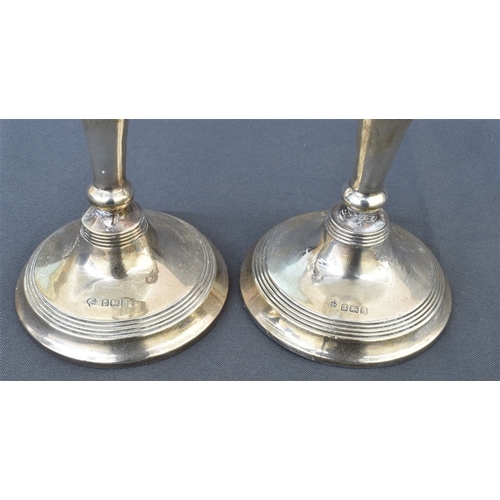 102 - A PAIR OF EDWARDIAN SILVER CANDLESTICKS standing 14.5cm tall, hallmarked Birmingham 1909.  Sponsors ... 