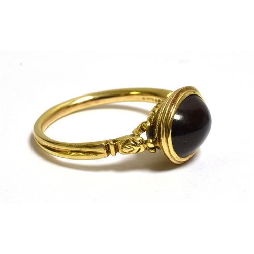 19 - 9CT GOLD GARNET CABOCHON DRESS RING 9.6 x 7.6mm oval pyrope garnet, bezel set in the style of an ant... 