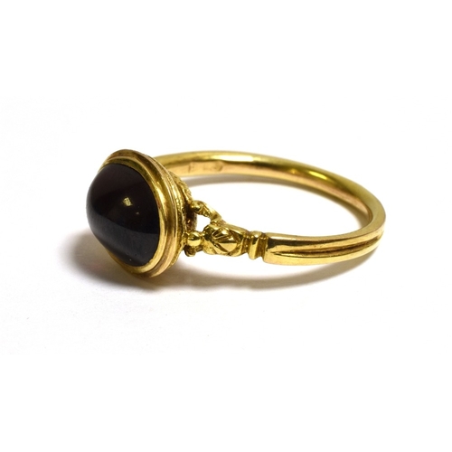 19 - 9CT GOLD GARNET CABOCHON DRESS RING 9.6 x 7.6mm oval pyrope garnet, bezel set in the style of an ant... 