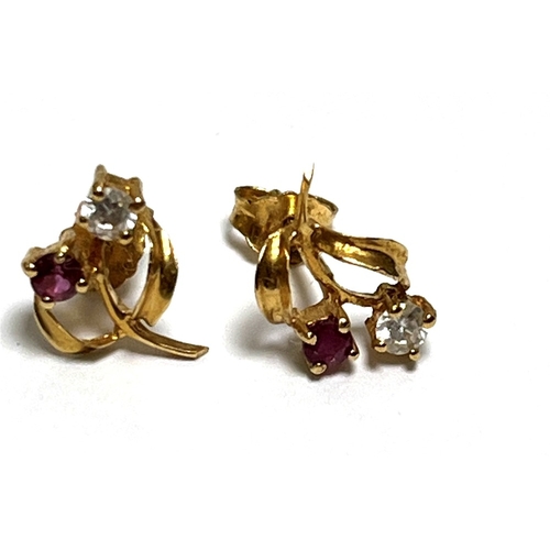 21 - 18CT GOLD RUBY & CZ SET STUD EARRINGS 10.9mm long x 7.0mm wide floral motif style on wire posts with... 