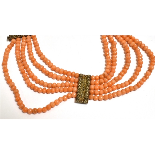 23 - ANTIQUE CORAL FESTOON NECKLACE Of collier d'esclavage style, 46cm long, consisting of five rows of 3... 