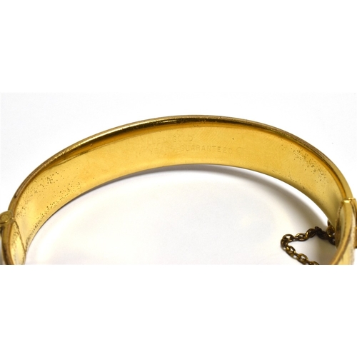 29 - ROLLED GOLD ENGRAVED BANGLE 12.6mm wide, scroll and bright cut engraved front, plain back with conce... 